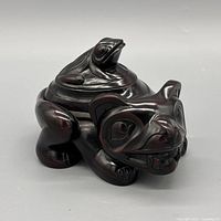 Front angled view of carved wood bear box with frog lid