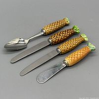 Top view of all four pineapple-handle utensils