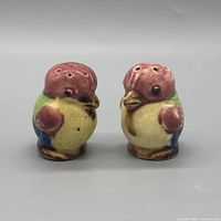 Front view of both ceramic bird shakers showing colours and condition