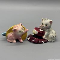 two ceramic cat shakers front view showing colours and wear