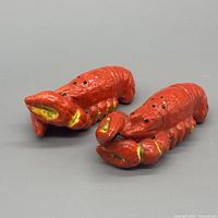Pair of red and yellow ceramic lobster shakers top view