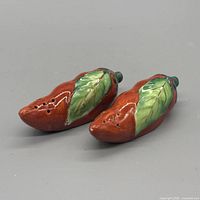Both ceramic shakers top view showing color, glaze and pour holes