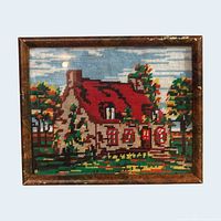 Front view of framed cross stitch showing full cottage landscape scene