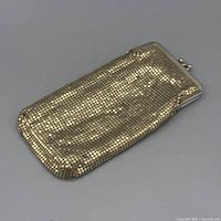 Front view of gold-tone metal mesh coin purse