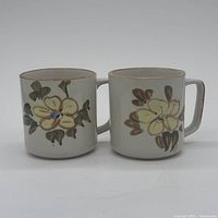 Front view of both ceramic mugs showing overall design and condition