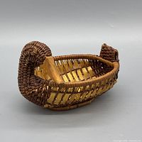 Side view of duck-shaped wicker basket showing weave and form