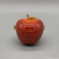 Front view red porcelain apple music box with gold trim
