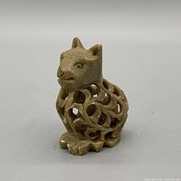 front view of carved soapstone cat with openwork body