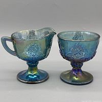 Front view of creamer and sugar bowl showing pattern and iridescent finish