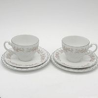 Full view of both place settings: teacups, saucers, plates