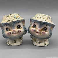 Front view of both kitten shakers showing faces and paint wear