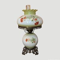 front view showing full lamp with painted shade, globe base, brass trim, chimney