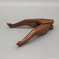 side view of carved wooden leg-shaped nutcracker, closed