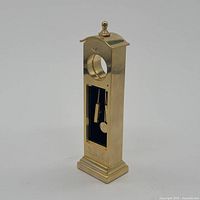 Front view showing aperture, pendulum, engraved motif