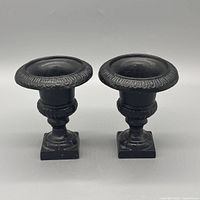 Front view of both cast iron urn candle holders