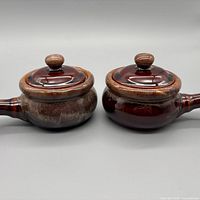 Pair of ceramic soup bowls with lids, frontal view