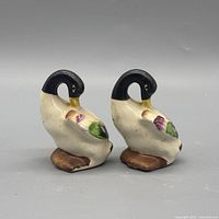Front three-quarter view of both ceramic duck figurines