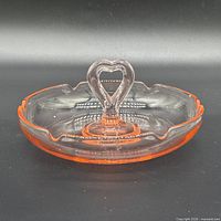 Top view showing full dish, heart handle, scalloped rim