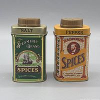 Front view of both spice tins showing graphics and lids
