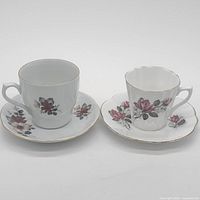 Front view of both teacups on saucers showing patterns and shape