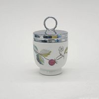 Front view showing butterfly motif and chrome lid