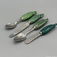 Top view of four utensils showing handles and stainless ends