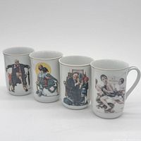 Front view of all four mugs showing different Rockwell scenes