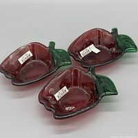Three red and green apple-shaped bowls top view