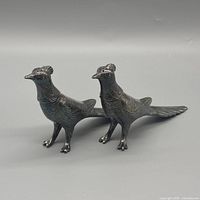 front three-quarter view of both bird shakers