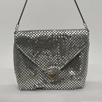 Front view of silver metal mesh evening bag showing envelope flap and clasp