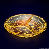 Dish under UV light glowing to show cadmium/uranium fluorescence