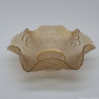 Top view showing square shape, floral embossing and ruffled rim