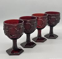 Four ruby red pressed glass goblets side view