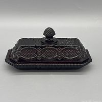 Covered butter dish front view showing pattern and color