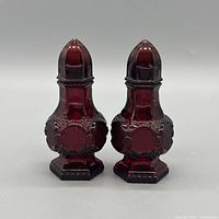 front view of both ruby red glass shakers