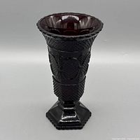 Full view of ruby red pressed glass vase front