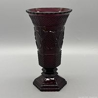 Full front view of ruby red pressed glass vase