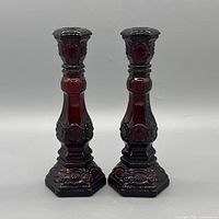 Front view of both ruby red Avon Cape Cod candlestick holders