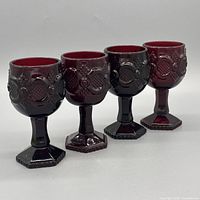 Front view of all four ruby red goblets showing overall design