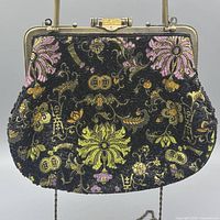 Front view of beaded floral handbag showing design, hardware and handle