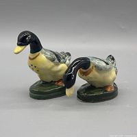 front three-quarter view of both ceramic duck shakers