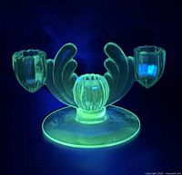 Candle holder glowing green under UV light