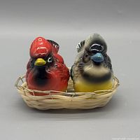 Front view of both bird shakers seated in basket