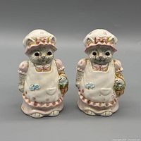 Front view of both kitten shakers showing facial features and painted attire