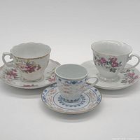 All three teacup and saucer sets displayed together