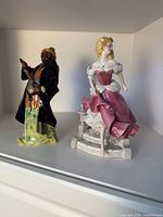 Front view of both figurines on shelf