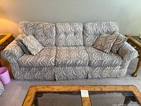 Front view of three-seat sofa with pillows