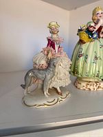 Seated lady figurine with greyhound