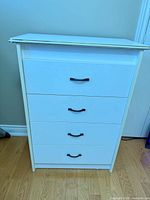 Front view of white 4-drawer dresser