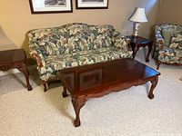 Full view of sofa, coffee table, and side tables